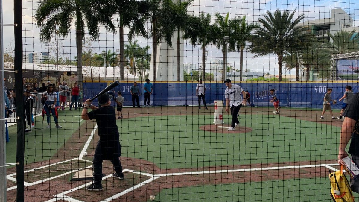 Kids taking batting practice on the wiffle field at the Miami Marlins FanFest